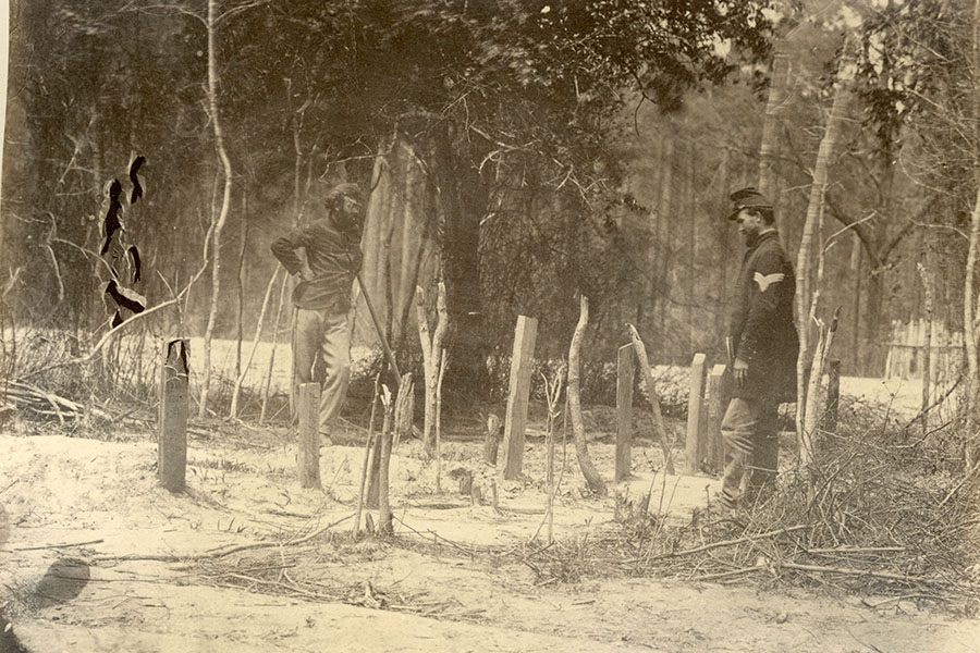 two soldiers stand at the burial place of the 3rd vt infantry