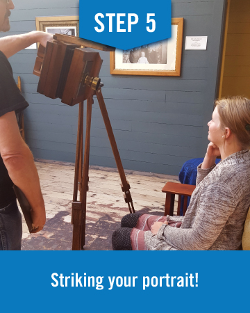 The man sets up the camera and positions it in front of the woman, this image reads "step 5 striking your portrait!"