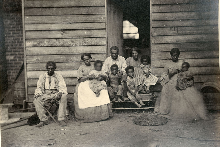 a black and white photo of five enslaved adult and five enslaved children at the gaine's house